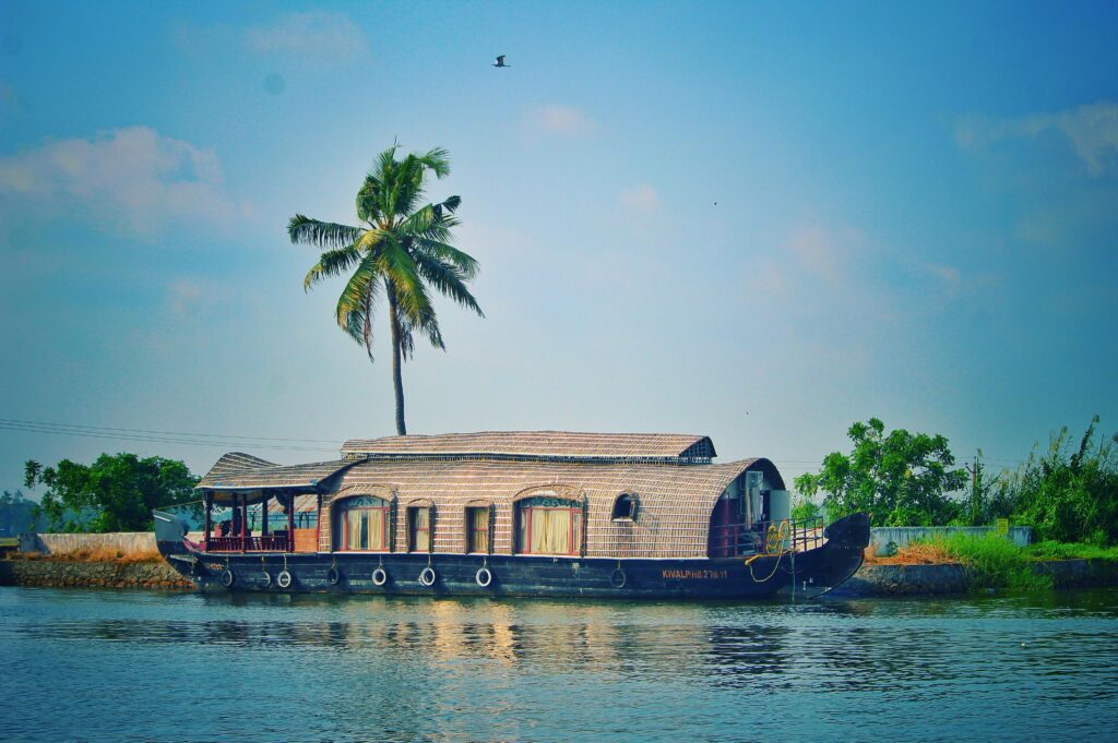 pexels-photo-962464-962464 Picturesque view of river with green palms on bank and shabby wooden boathouse under blue sky in tropical countryside