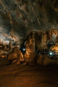 Explore the intricate formations of a limestone cave, showcasing surreal stalactites and stalagmites.