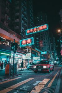 Explore the bustling nightlife of Kowloon, Hong Kong with neon lights and city life.