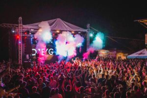 Lively outdoor music festival with vibrant lights, crowd energy, and a dynamic performance.